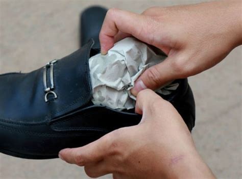 stretching tight shoes with newspaper